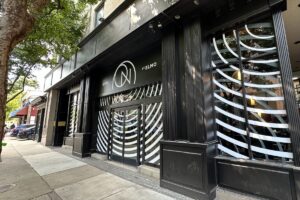 Exterior of On St. Elmo, a black building with black and white spiral design on door and windows. (Photo: Ella Griffin)