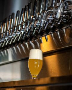 A draft beer with a foam head sitting under a tap. (Photo: Churchkey/Facebook) 