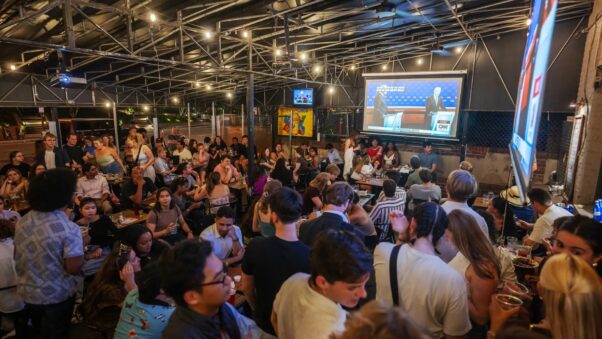 People sitting and standing at Union Pub watching the presidential debate on a TV. (Craig Hudson/The Washington Post/Getty Images)