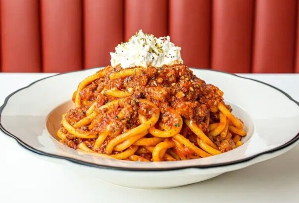 Spaghetti with meat sauce topped with parmesan cheese. (Photo: Caruso's Grocery)