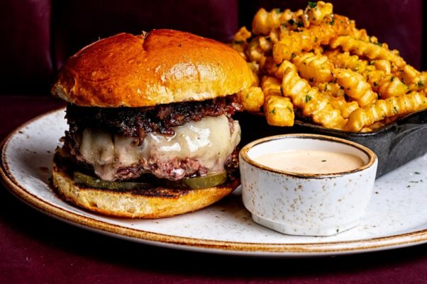 The Farmhouse Burger with aged beef brisket, white cheddar, pickles, farmhouse sauce and
bacon onion jam on a brioche bun served with fries. (Photo: The Farmhouse Bistro)

