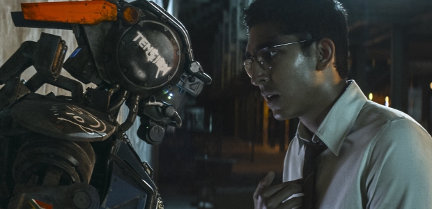 CHAPPiE (Sharlto Copley, left) and his creator Deon (Dev Petal) in CHAPPiE. (Photo: Sony Pictures)